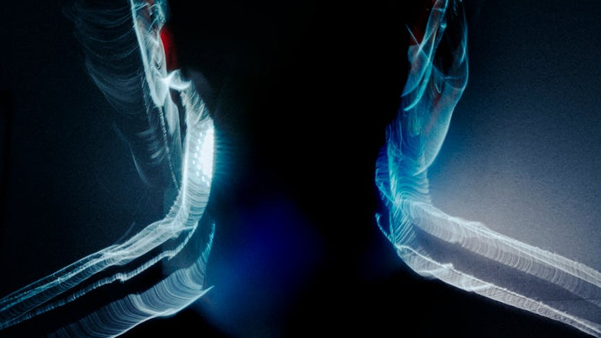 Abstract silhouette of a person in motion with fluid light trails.